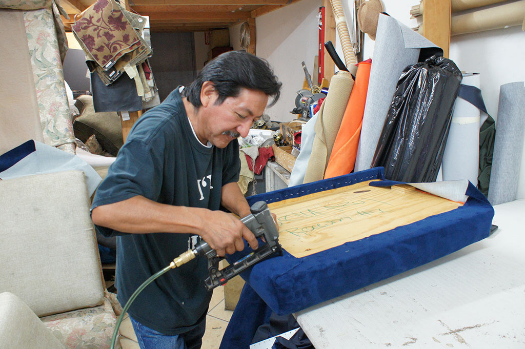 Upholsterer working  at Lopez Upholstery Los Angeles
